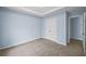 This carpeted bedroom features a trey ceiling, blue walls, and a closet with double doors at 5380 Rock Place Drive, Stone Mountain, GA 30087