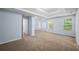 Large carpeted bedroom with tray ceiling and multiple windows at 5380 Rock Place Drive, Stone Mountain, GA 30087