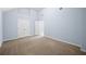 This bedroom has a vaulted ceiling, carpet, and light blue walls at 5380 Rock Place Drive, Stone Mountain, GA 30087
