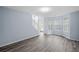 Comfortable living room with hardwood floors, stairs and large windows at 5380 Rock Place Drive, Stone Mountain, GA 30087