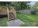 View of the backyard featuring a wooden deck with stairs and a wooden fence at 6797 Braswell Mountain Rd, Rockmart, GA 30153