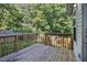 Wood deck overlooking a green backyard, perfect for entertaining or enjoying nature at 6797 Braswell Mountain Rd, Rockmart, GA 30153