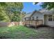 View of the house from the backyard featuring a wooden deck and manicured lawn at 6797 Braswell Mountain Rd, Rockmart, GA 30153