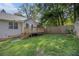 A house's backyard features a wooden deck, a fenced yard and manicured lawn at 6797 Braswell Mountain Rd, Rockmart, GA 30153