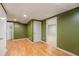 Basement featuring wood-look floors, olive-green walls, and multiple doorways at 6797 Braswell Mountain Rd, Rockmart, GA 30153
