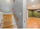 Staircase leading to a finished basement with wood-look flooring at 6797 Braswell Mountain Rd, Rockmart, GA 30153