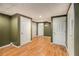 Finished basement area featuring wood-look flooring, neutral carpet, and multiple doorways at 6797 Braswell Mountain Rd, Rockmart, GA 30153