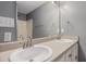 Bathroom vanity with double sinks, white cabinetry, and a large mirror at 6797 Braswell Mountain Rd, Rockmart, GA 30153