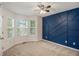Bedroom showcases a modern accent wall, a ceiling fan, and a bay window at 6797 Braswell Mountain Rd, Rockmart, GA 30153