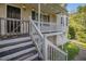 Inviting front porch with steps leading up to the entrance and string lights at 6797 Braswell Mountain Rd, Rockmart, GA 30153