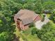 Expansive brick home in a wooded setting, showcasing a large yard, deck, and mature trees at 169 Robson Trl, Mcdonough, GA 30252