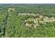 A scenic aerial view showcases a neighborhood nestled amongst dense green trees and well-manicured lawns at 169 Robson Trl, Mcdonough, GA 30252