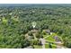 Expansive aerial view of a neighborhood with lush green trees surrounding beautiful homes at 169 Robson Trl, Mcdonough, GA 30252