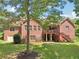 Brick home featuring expansive backyard, a patio, and lush greenery providing a private outdoor space at 169 Robson Trl, Mcdonough, GA 30252
