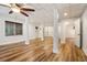 Large basement with laminate flooring, ceiling fan, and white support columns at 169 Robson Trl, Mcdonough, GA 30252