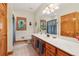 Bathroom featuring modern fixtures, double sinks, and a large mirror at 169 Robson Trl, Mcdonough, GA 30252