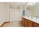 Well-lit bathroom featuring ceramic tile flooring, a wooden vanity and a shower with curtain at 169 Robson Trl, Mcdonough, GA 30252