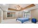 Calm bedroom featuring an elegant ceiling fan and an eye-catching recessed ceiling at 169 Robson Trl, Mcdonough, GA 30252