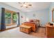Bright bedroom with large window, ceiling fan, and comfortable furniture at 169 Robson Trl, Mcdonough, GA 30252