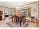 Dining area featuring a bay window with trim, table with seating, and tile flooring at 169 Robson Trl, Mcdonough, GA 30252