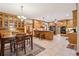 Spacious kitchen features wooden cabinetry, a central island with seating, and a dining area at 169 Robson Trl, Mcdonough, GA 30252