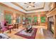 Cozy living room with hardwood floors, a brick fireplace, and natural light at 169 Robson Trl, Mcdonough, GA 30252