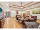 Bright living room featuring hardwood floors, coffered ceilings, and comfortable leather seating at 169 Robson Trl, Mcdonough, GA 30252