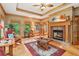 Inviting living room featuring a fireplace, hardwood floors, and multiple windows at 169 Robson Trl, Mcdonough, GA 30252
