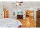 Main bedroom featuring hardwood floors, tray ceilings, and wooden door frames at 169 Robson Trl, Mcdonough, GA 30252