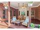 Relaxing covered patio with brick accents, overhead fan, and comfortable chairs at 169 Robson Trl, Mcdonough, GA 30252