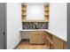 A bar area boasts wood floors, white counters, custom cabinets, and a sink for entertaining at 2369 Mcafee Rd, Decatur, GA 30032
