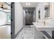 A luxurious bathroom features marble floors, a double sink vanity with gold fixtures, and a glass enclosed shower at 2369 Mcafee Rd, Decatur, GA 30032