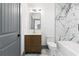 This bathroom features marble tile surround, a tub, and a modern vanity at 2369 Mcafee Rd, Decatur, GA 30032