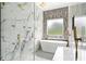 This bathroom features marble tile, dual shower heads, and a luxurious soaking tub at 2369 Mcafee Rd, Decatur, GA 30032