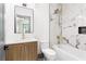 This bathroom features marble tile surround, a tub, and a modern vanity at 2369 Mcafee Rd, Decatur, GA 30032