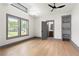 This bedroom features gray trim, hardwood floors, a ceiling fan, and many windows at 2369 Mcafee Rd, Decatur, GA 30032