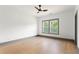 This bedroom has gray trim, hardwood floors, a ceiling fan, and windows at 2369 Mcafee Rd, Decatur, GA 30032