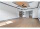 A spacious bedroom features hardwood floors, a modern ceiling fan, and gray trim throughout the room at 2369 Mcafee Rd, Decatur, GA 30032