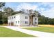 Wide angle view of a two-story home and driveway with a combination stone and light gray exterior at 2369 Mcafee Rd, Decatur, GA 30032