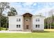 Two-story home with a stone facade, light gray exterior, covered entrance, and landscaped front yard at 2369 Mcafee Rd, Decatur, GA 30032