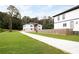 Two story home with a combination stone and light gray exterior, long driveway and green grass at 2369 Mcafee Rd, Decatur, GA 30032