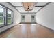 Open concept living space with hardwood floors, modern fireplace, ceiling fan and decorative lighting at 2369 Mcafee Rd, Decatur, GA 30032
