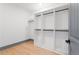 A large walk-in closet is complete with wood floors, built-in shelving, and space for hanging storage at 2369 Mcafee Rd, Decatur, GA 30032