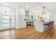 Bright kitchen with island seating, modern appliances, white cabinets and hardwood flooring throughout at 2813 Hillside Rd, Smyrna, GA 30080