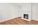 Living room featuring a white fireplace, wood-look flooring, and white walls at 2813 Hillside Rd, Smyrna, GA 30080