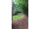 Landscaped backyard with view of gated fence and grass, adding a touch of security and charm at 5190 Southlake Dr, Alpharetta, GA 30005