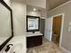 Bathroom with double sink vanity, tiled floors, and separate tub and shower at 5190 Southlake Dr, Alpharetta, GA 30005
