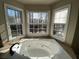 Large soaking tub in the bathroom with three windows providing lots of natural light at 5190 Southlake Dr, Alpharetta, GA 30005