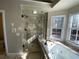 Modern bathroom featuring a glass enclosed shower and a large soaking tub at 5190 Southlake Dr, Alpharetta, GA 30005