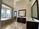 Bathroom featuring tiled floors, double sinks, and a soaking tub by a window at 5190 Southlake Dr, Alpharetta, GA 30005